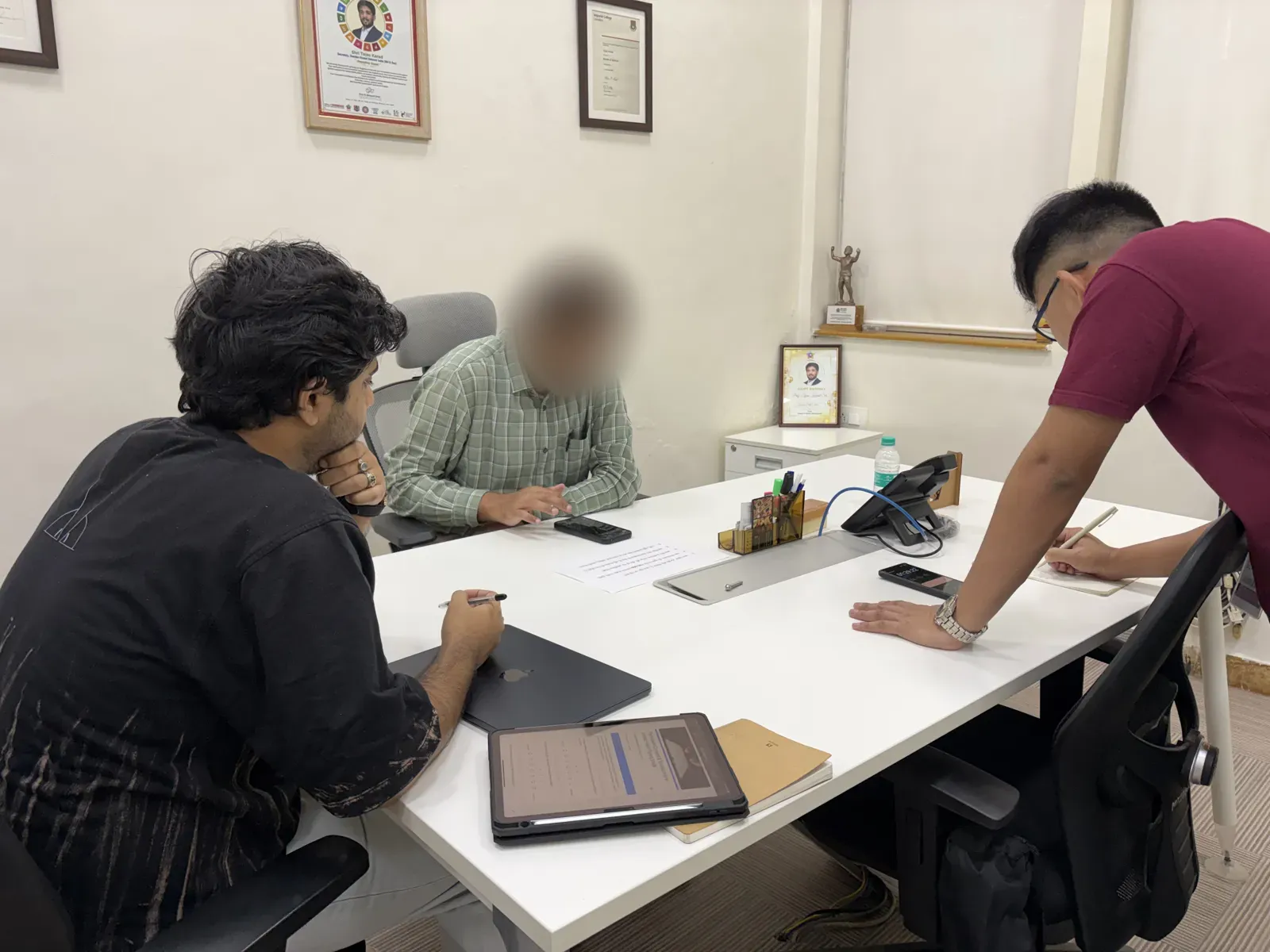 A team member briefing a participant at a desk before the test