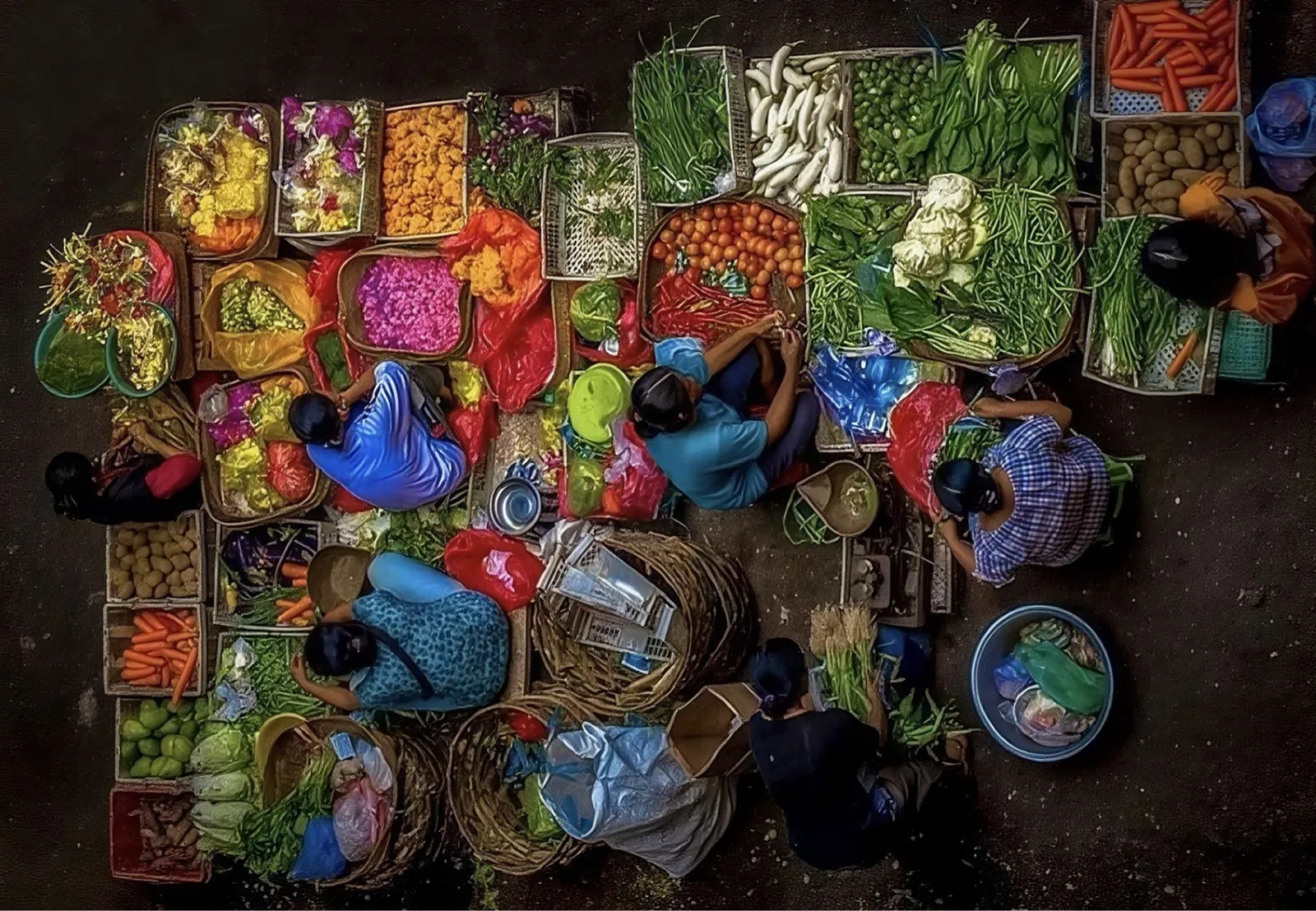 Overhead view of vendors and produce at a busy open-air market